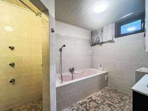 a bathroom with a bath tub and a sink at Holiday Home LuxuSölk-5 by Interhome in Stein an der Enns