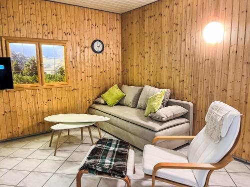 a living room with a couch and a table at Studio The Green Studio by Interhome in Stein an der Enns