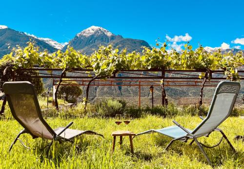 two chairs and a table in a field of grass at La Vrille - Metcho in Verrayes