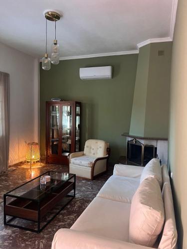 a living room with a couch and a coffee table at Veranda Home in Petrití