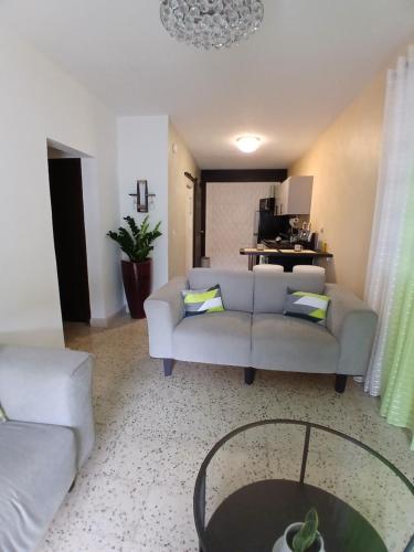 a living room with a couch and a table at Trujillo House Vacation in Trujillo Alto