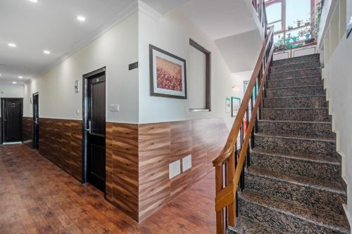a staircase in a house with wooden floors at Treebo Maharaja, Near Mall Road in Shimla
