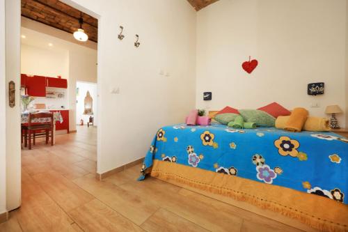 a bedroom with a blue bed in a room at Casa Dalu nel centro di Ostia Antica in Ostia Antica