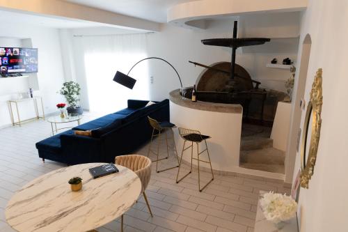 a living room with a blue couch and a table at Moulin du désir in Montauroux