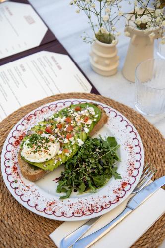 a plate with two slices of bread with vegetables on it at Hotel de Silhouette in Biarritz