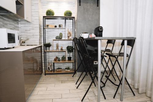 a kitchen with a table and chairs in a room at 47 Steps in Rome