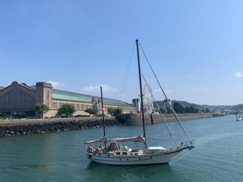 a sailboat floating in the water in a river at La Passerelle in Cherbourg en Cotentin