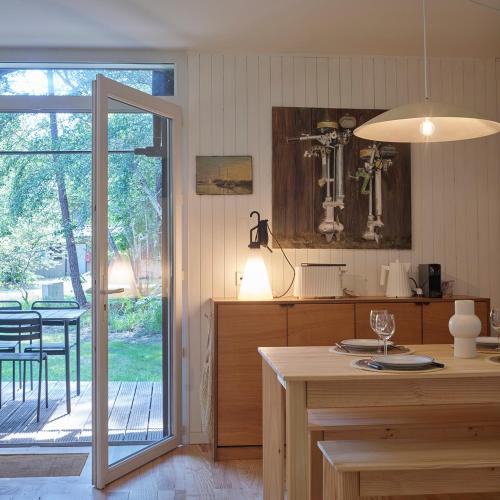 a kitchen with an open door to a patio at Villa Marina de Talaris, Lacanau in Lacanau