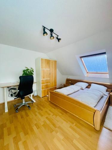 a bedroom with a bed and a desk and a chair at Neuenhagen Haven in Neuenhagen