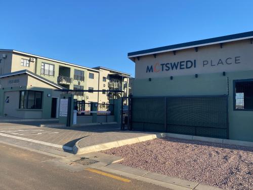 an empty street in front of a building at Unit B1 Motswedi Place in Gaborone