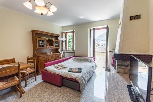 a bedroom with a bed and a desk and a fireplace at Appartamento vista Grigna, Natura,sport e relax in Primaluna