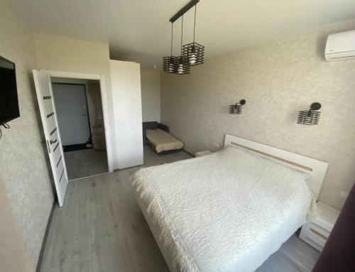 a bedroom with a white bed in a room at Cosy 1-bedroom apartment in Odessa in Odesa