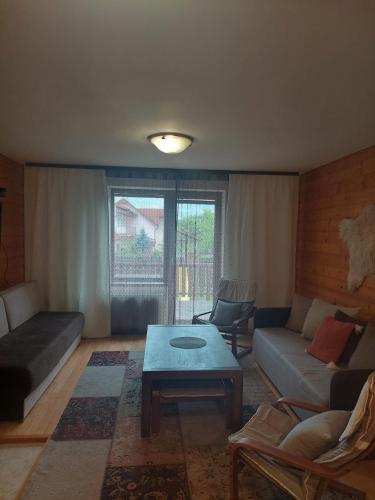 a living room with a couch and a coffee table at vila Happy in Veľká Lomnica