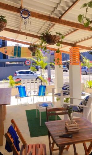 a patio with a table and chairs and a boat at Pousada Sete Mares Manaira in João Pessoa