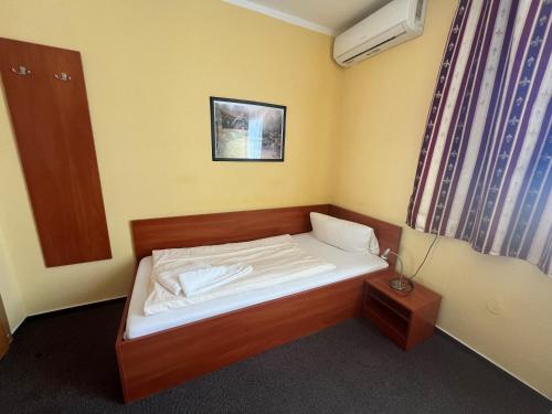 a small bedroom with a small bed in a room at Pension Garbsen in Garbsen