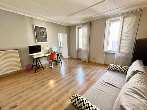 a living room with a couch and a table at La circulade - Maison de caractère avec jardin in Bram