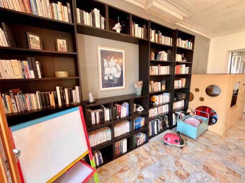 a room with large book shelves filled with books at La circulade - Maison de caractère avec jardin in Bram