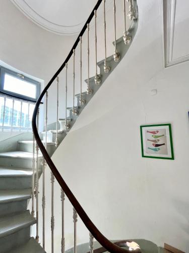 a winding staircase in a house with white walls and a stair case at La circulade - Maison de caractère avec jardin in Bram