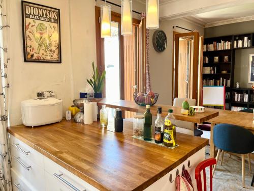 a kitchen with a counter with bottles of wine on it at La circulade - Maison de caractère avec jardin in Bram