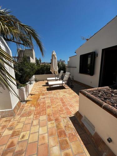 a patio with chairs and an umbrella on a building at Palacio Ca Sa Galesa in Palma de Mallorca