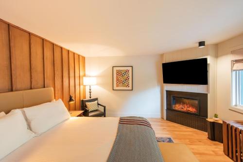 a hotel room with a bed and a fireplace at Historic Rocky Waters Inn, A Small Luxury Hotel in Gatlinburg