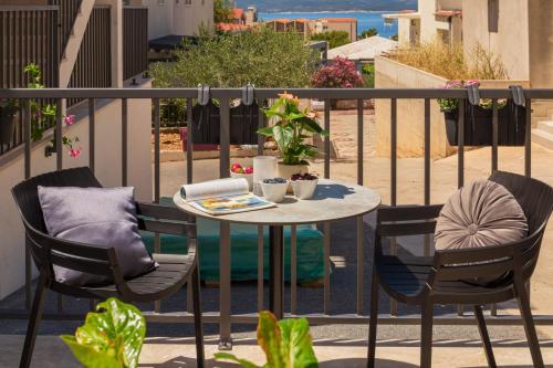 a small table and two chairs on a balcony at Apartments Ivan in Baška Voda