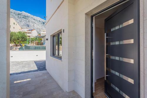 a door to a building with a view of a pool at Apartments Ivan in Baška Voda