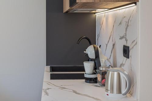 a kitchen counter with a coffee maker and a mixer at Apartments Ivan in Baška Voda