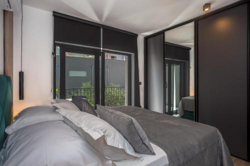 a bedroom with a large bed with white pillows at Apartments Ivan in Baška Voda