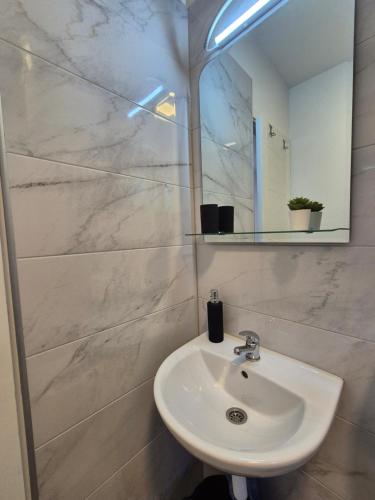 a bathroom with a sink and a mirror at Old Town Bistrik - Free parking in Sarajevo
