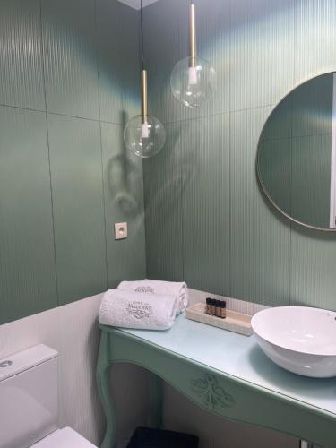 a bathroom with a sink and a mirror at Quinta de Maderne in Felgueiras
