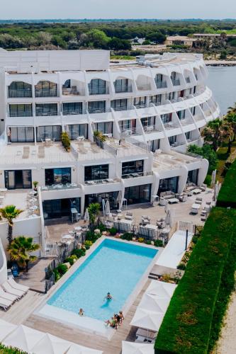an aerial view of the resort with a swimming pool at Hôtel La Plage 5 étoiles La Grande Motte in La Grande-Motte