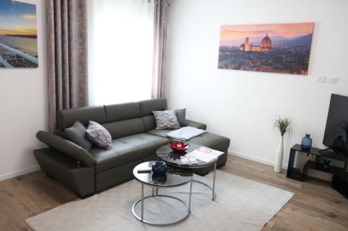 a living room with a couch and a table at DolceVita apartment in Como