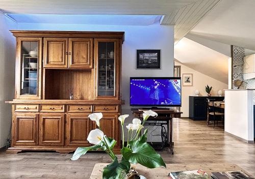 a living room with a large entertainment center and a tv at La mansardina in Venegono Superiore