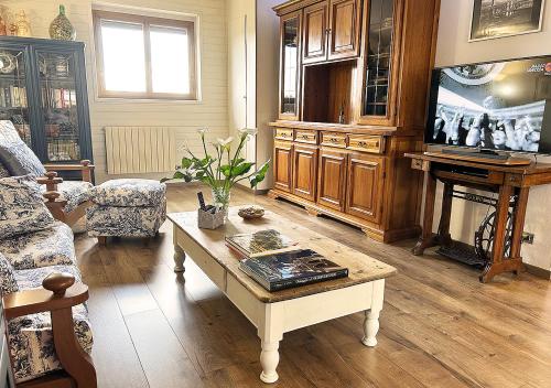 a living room with a coffee table and a tv at La mansardina in Venegono Superiore