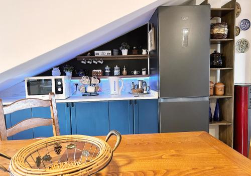 a kitchen with a table and a refrigerator at La mansardina in Venegono Superiore