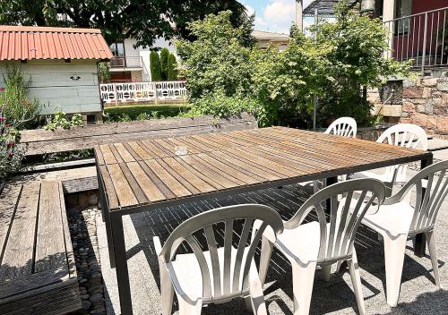 a wooden table and four chairs sitting around a table at La mansardina in Venegono Superiore