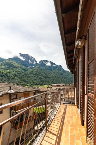 a balcony of a building with mountains in the background at Appartamento vista Grigna, Natura,sport e relax in Primaluna