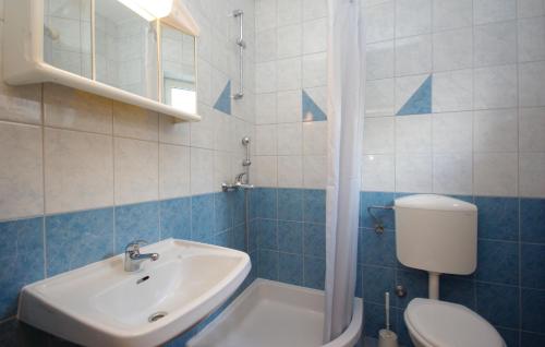 a bathroom with a white toilet and a sink at White Hill Studio-Apartments in Makarska