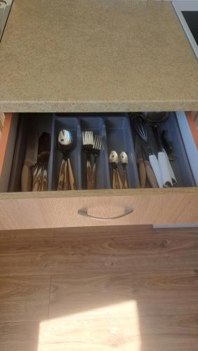 a drawer filled with utensils in a kitchen at Jaukus butas arti Šiaulių miesto in Šiauliai