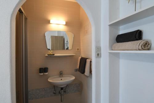 a small bathroom with a sink and a mirror at Haus Stefan in Oetz