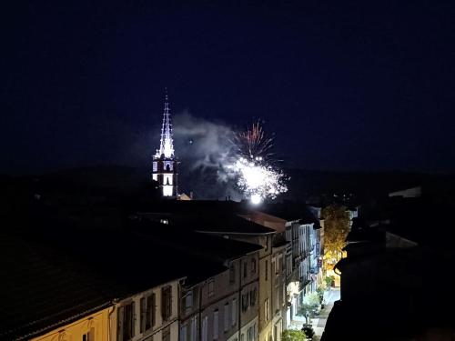 a fireworks display in the sky over a city at night at La terrasse des Augustins in Limoux