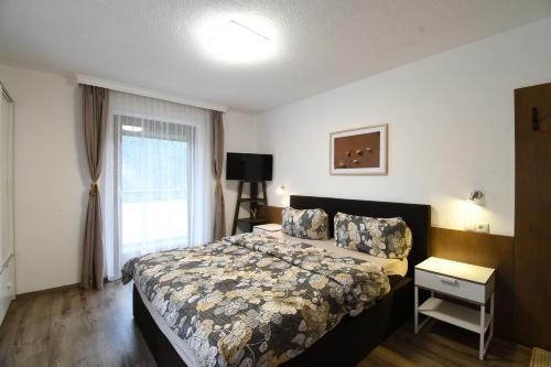 a bedroom with a bed and a window at Haus Stefan in Oetz