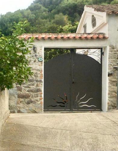 a black garage door with a deer painted on it at Kelu e Terra - Locazione Turistica - IUN Q0467 in Onifai