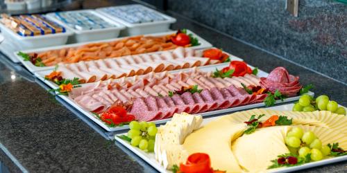 a display of different types of meats and cheese at PLAZA Residence Stuttgart-Ditzingen in Ditzingen