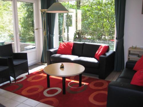 a living room with a couch and a table at Holiday Home 6L-5 by Interhome in Lochem
