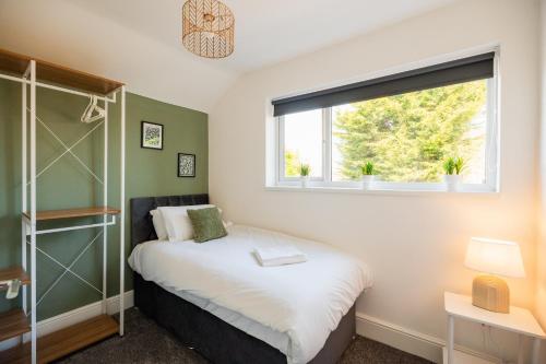 a small bedroom with a bed and a window at Rockliffe House By Horizon Stays in Middlesbrough