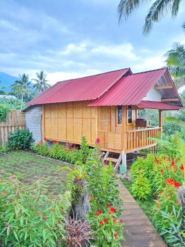 a small wooden house with a red roof at Kurni's Cabin in Sapit