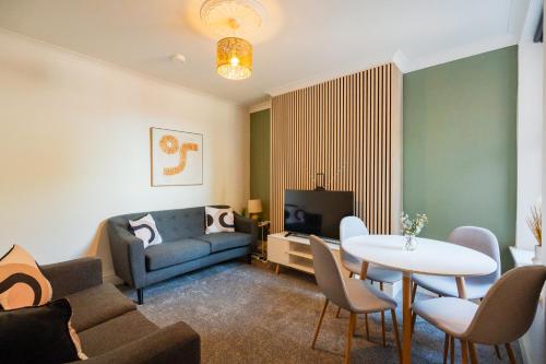 a living room with a couch and a table at Rockliffe House By Horizon Stays in Middlesbrough