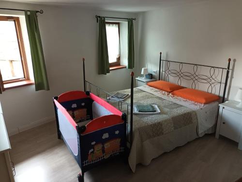 a bedroom with a bed with orange pillows at Le dolomiti di Angelo in Voltago